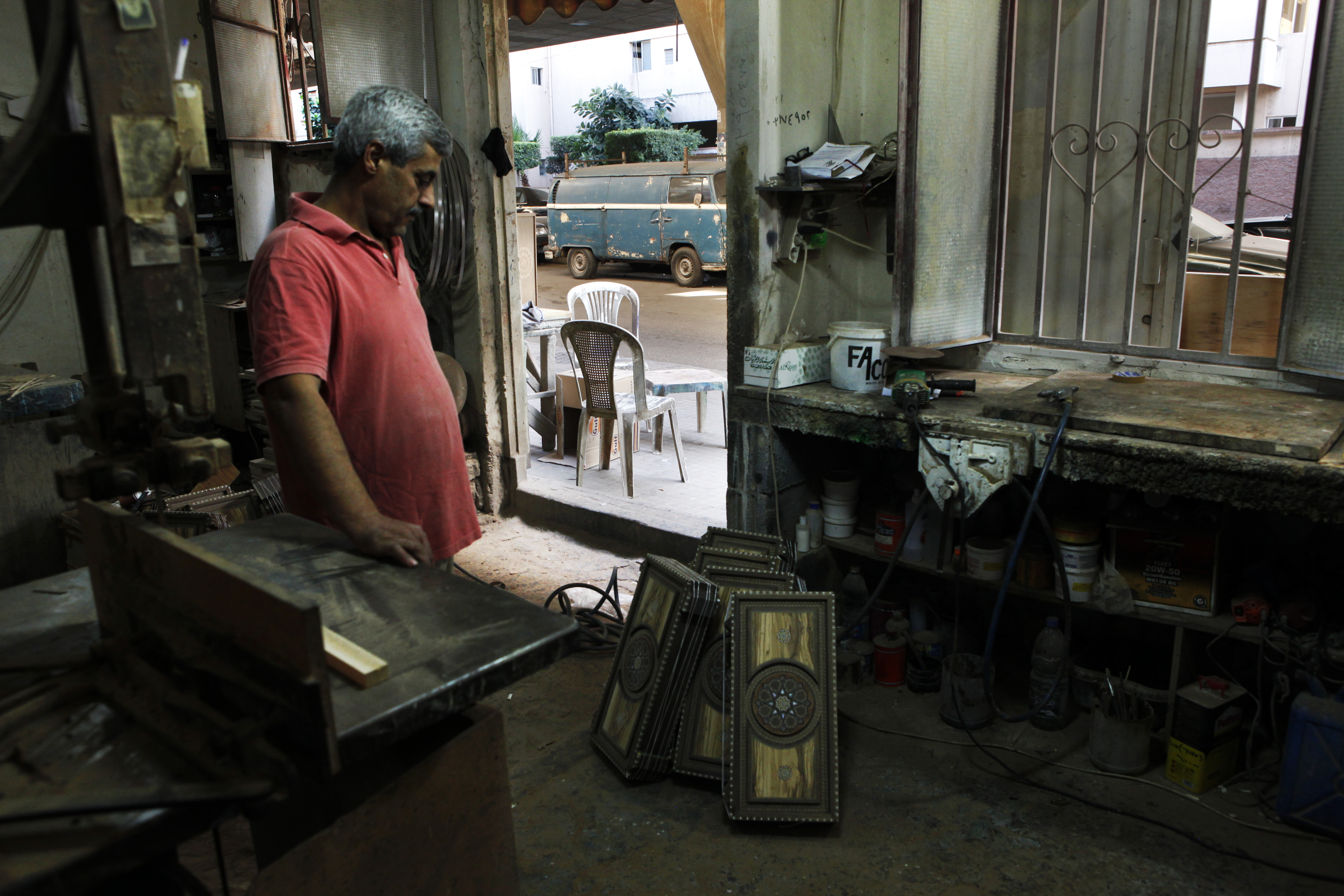 November 1, 2015 Nabaa, Bourj Hammoud, Beirut, Lebanon George admires a completed set of backgammon boards as he pauses between work. George is relatively lucky compared to other Syrians in Bourj Hammoud, as he is well established with a stable job. The sub-district where he works has seen sometimes violent communal tensions between local Armenians and Syrians as conditions deteriorate and Armenians fear being outnumbered by Syrians in what they consider their own backyard.