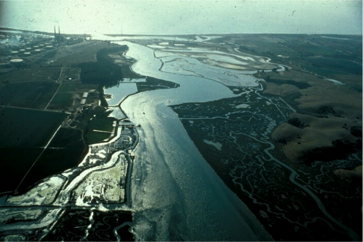 Aerial photo of Elkhorn Slough, looking west toward Moss Landing and Monterey Bay. The Deep Water Desal facility is proposed on the property in the upper left where an old crude oil storage tank farm was once located. (Moss Landing Marine Laboratories/California State Universities)