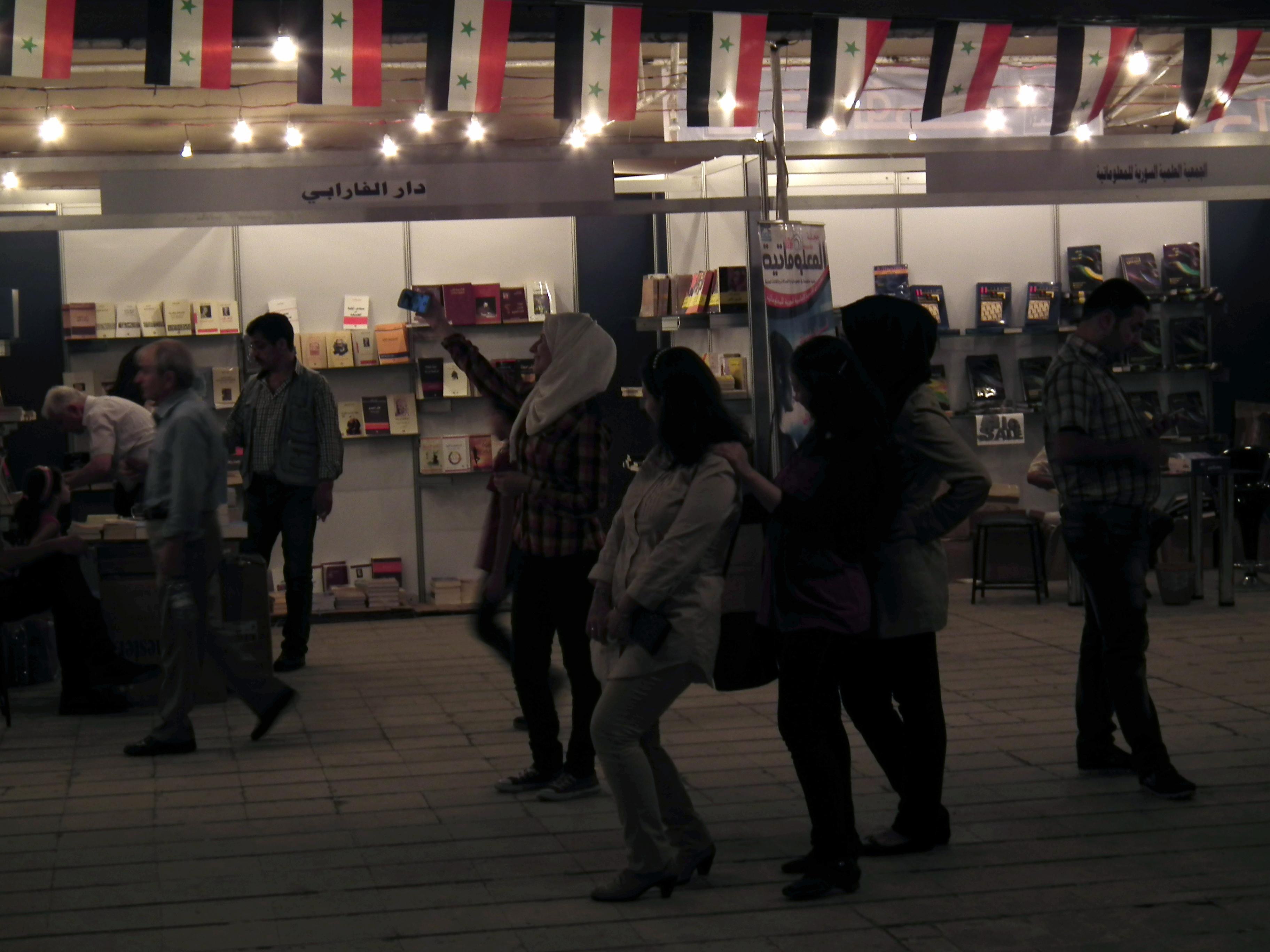 A woman takes a selfie at the Damascus International Book Fair. (Muhammad Kheir al-Hamwi)