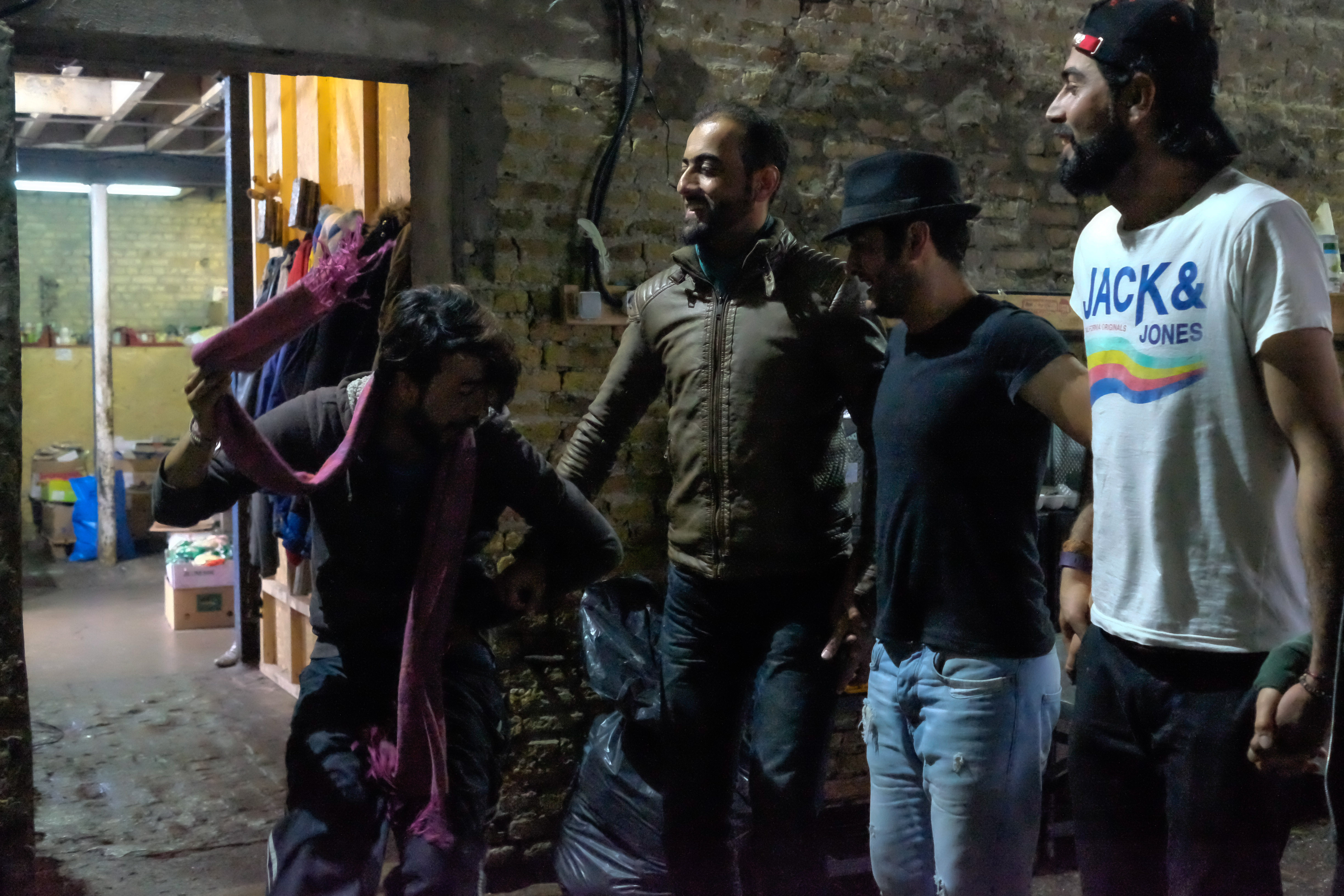 Hama Sheren (far left) and other Iraqi Kurdish refugees living in the camp dance dabke during a cigarette break. (Razan Alzayani)