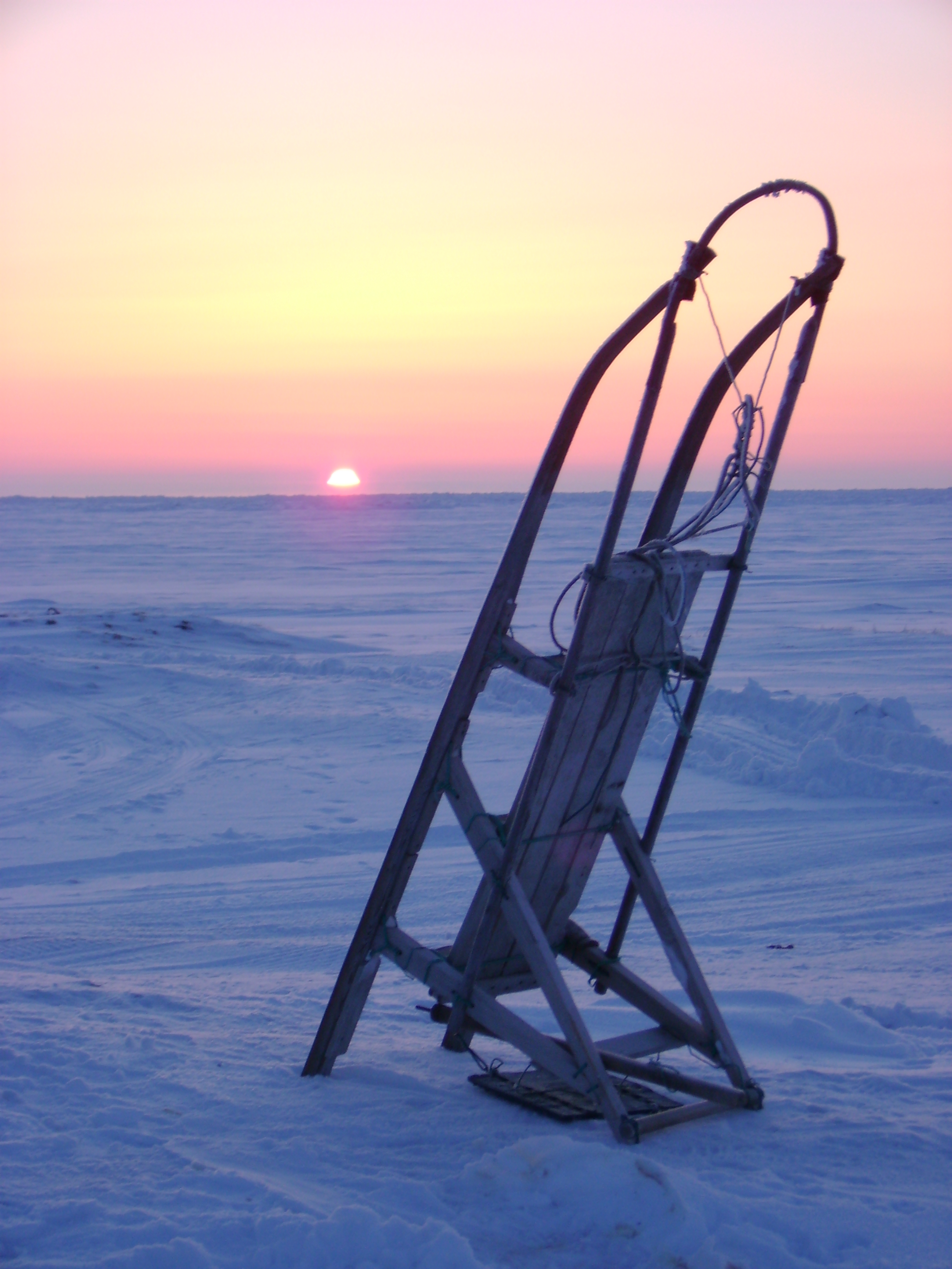 A spring sunset is seen behind a sled. (Photo Courtesy Craig Perham)