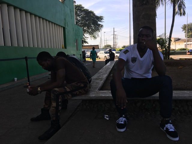 People wait outside the immigration center of Tapachula, Estacion Siglo XX, in December 2016. (Irene Savio)