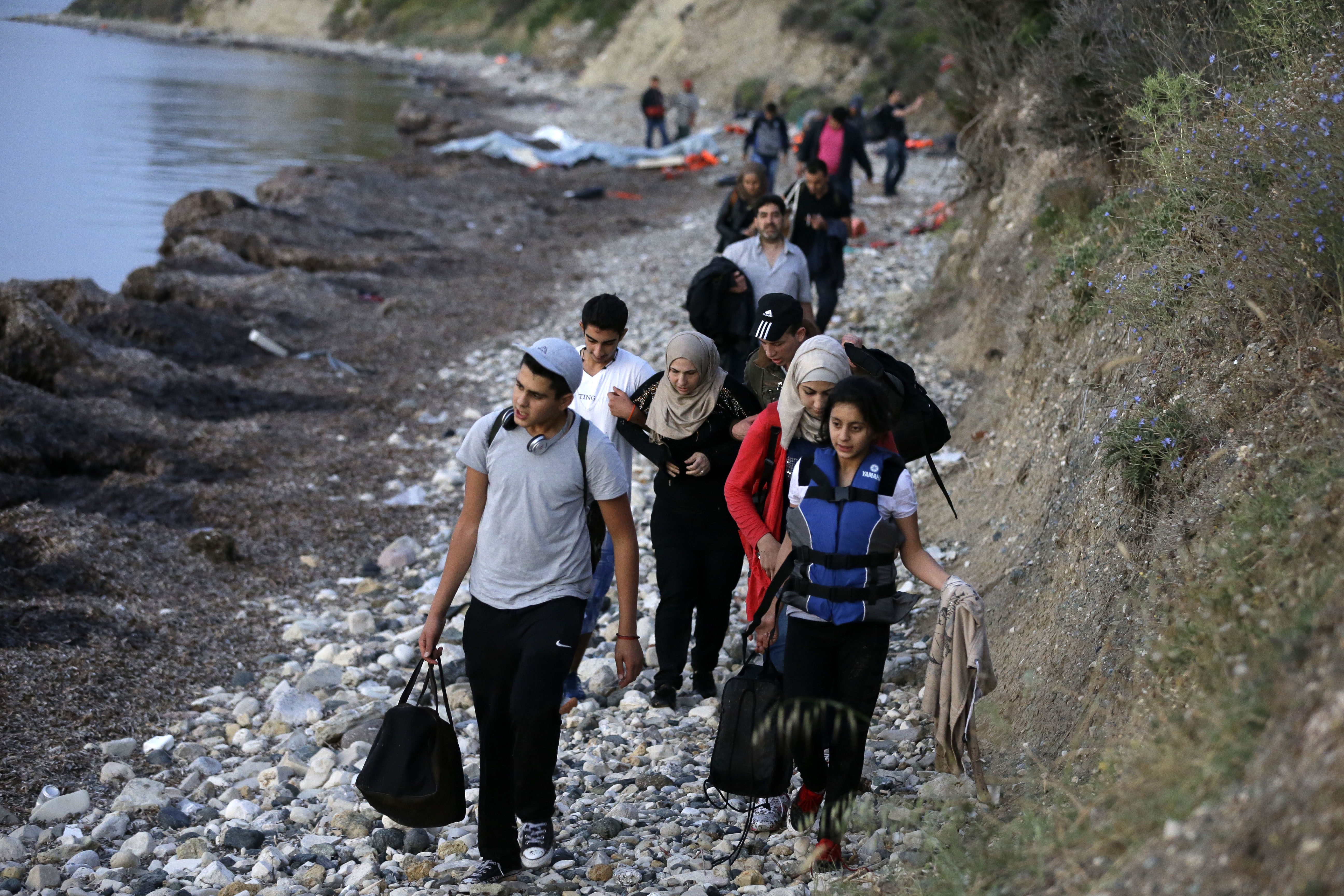 Syrian refugees arrive from the Turkish coast at a beach in Mytilene, on the northeastern Greek island of Lesvos. (AP/Thanassis Stavrakis)